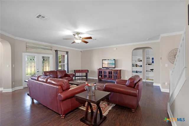 a view of a dining room with furniture wooden floor and a chandelier