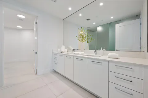 a bathroom with a toilet a sink a tub and a mirror