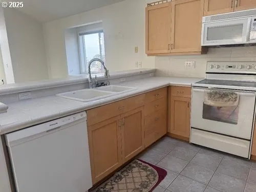 a kitchen with sink and cabinets