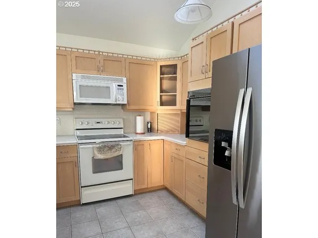 a kitchen with stainless steel appliances a refrigerator stove and sink
