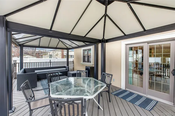 a table and chairs in patio of the house