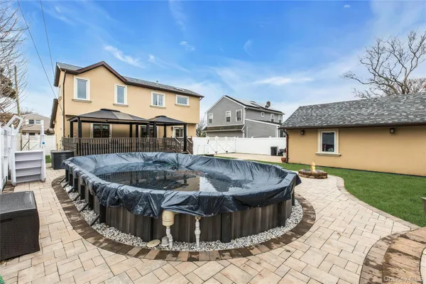 a view of a house with pool and chairs
