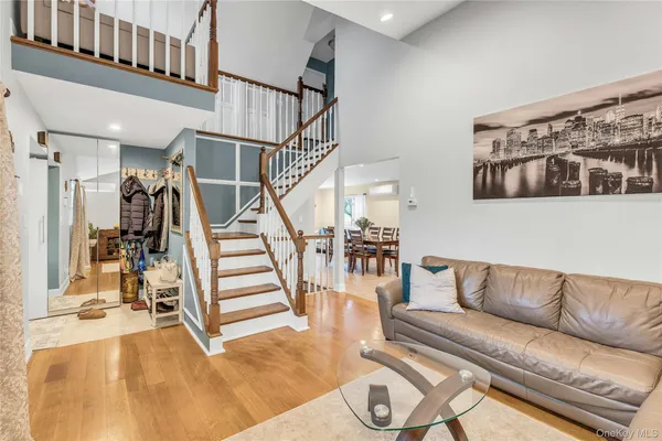 a living room with furniture with wooden floor and stairs