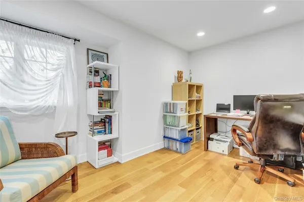 a bedroom with a workspace and a couch