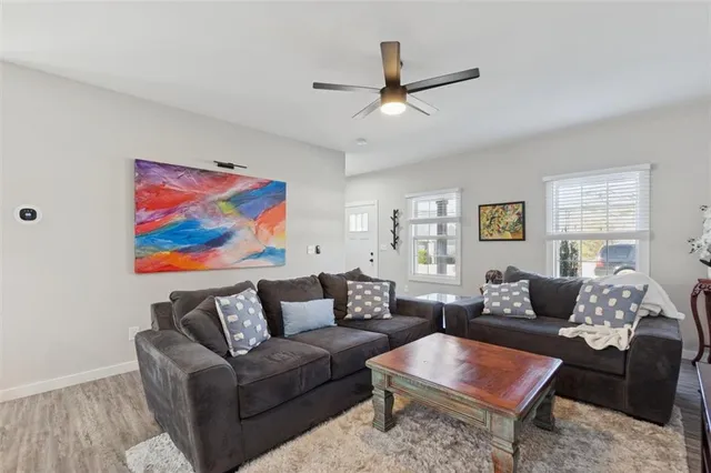 a living room with furniture and a wooden floor