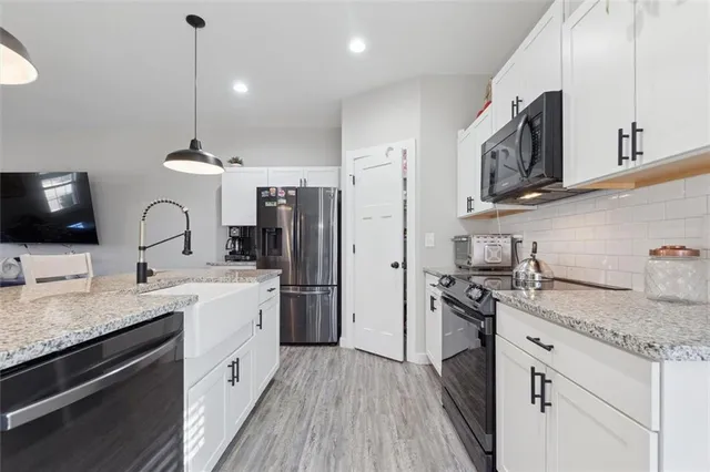 a kitchen with a sink stove and refrigerator