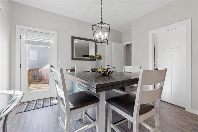 a view of a dining room with furniture a chandelier and wooden floor