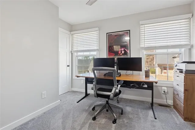 a bedroom with a bed a ceiling fan and a window