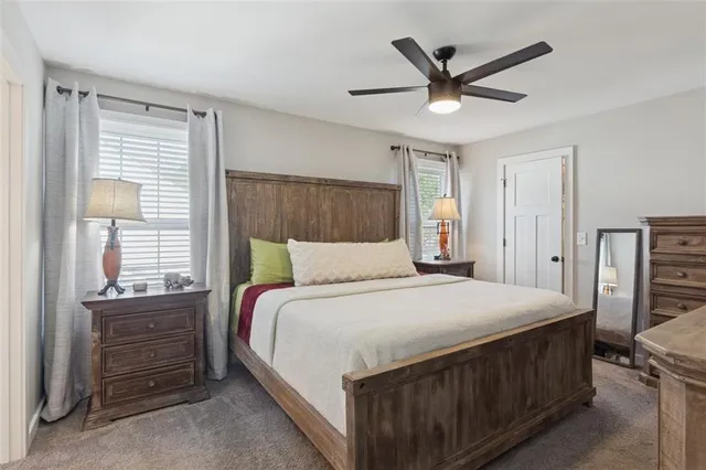 a bedroom with a large bed and a window