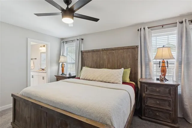 a bathroom with a granite countertop sink mirror vanity and toilet