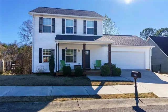 a front view of a house with garden