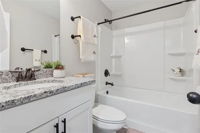 a large bed sitting in a bedroom next to a window