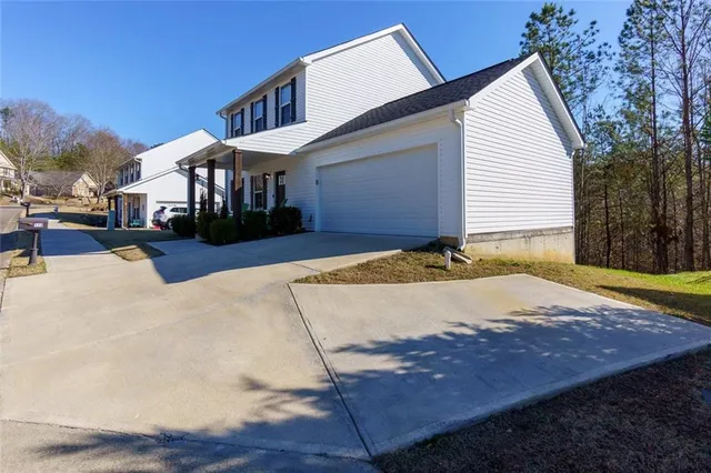 a view of a house with snow on the road