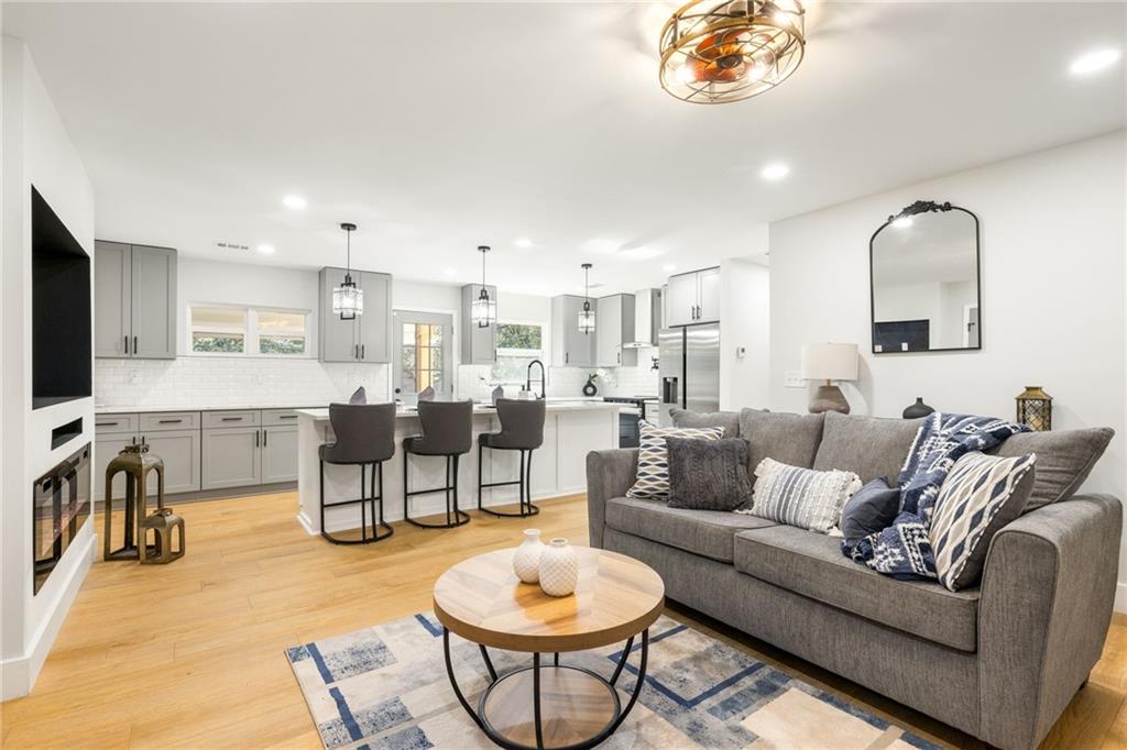 2633 Yale Terrace Decatur, GA 30032 - Photo 13 of 21 a living room with furniture a flat screen tv and kitchen view