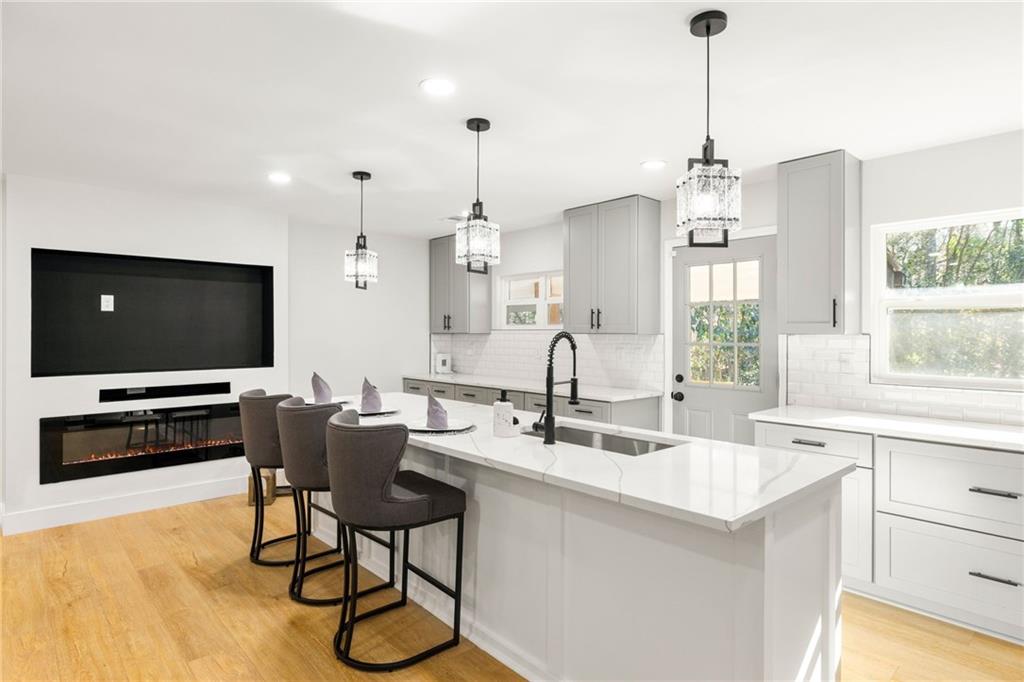 2633 Yale Terrace Decatur, GA 30032 - Photo 15 of 21 a kitchen with stainless steel appliances kitchen island granite countertop a sink a stove and a table
