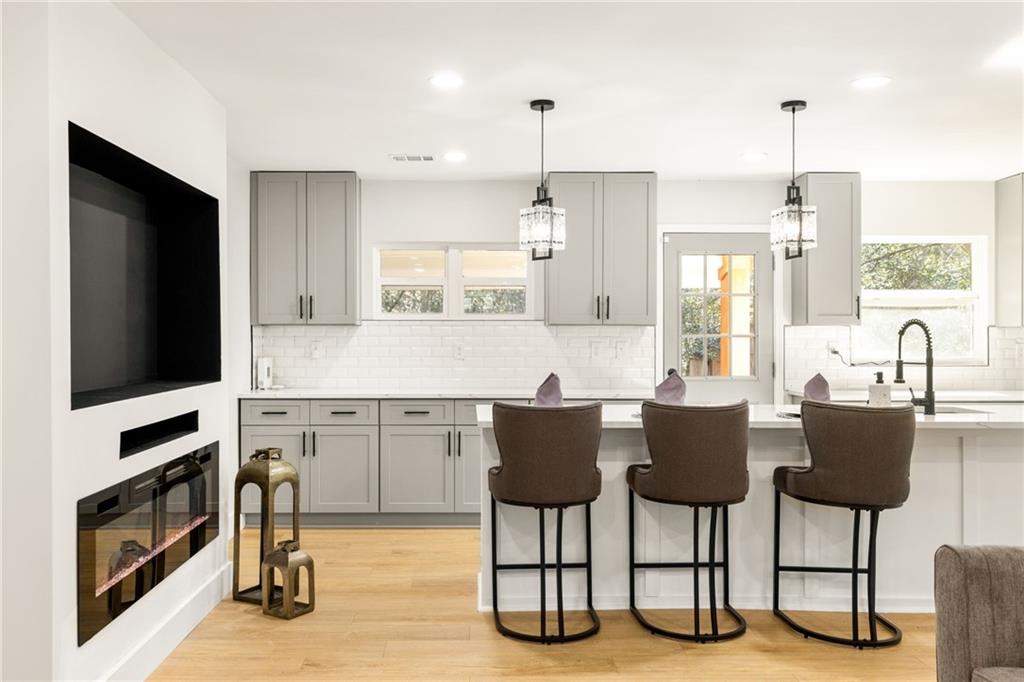 2633 Yale Terrace Decatur, GA 30032 - Photo 16 of 21 a kitchen with a kitchen island hardwood floor and a sink