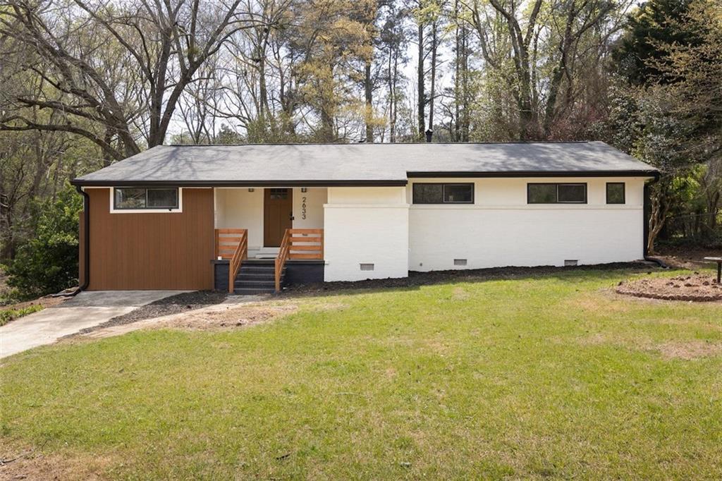 2633 Yale Terrace Decatur, GA 30032 - Photo 2 of 21 a front view of house with yard and trees in the background