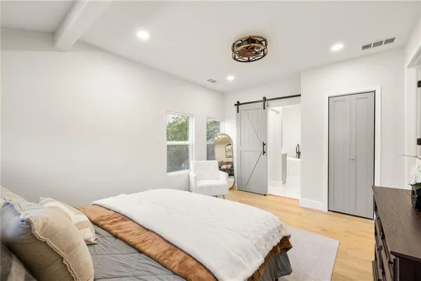 a living room with furniture a flat screen tv and kitchen view
