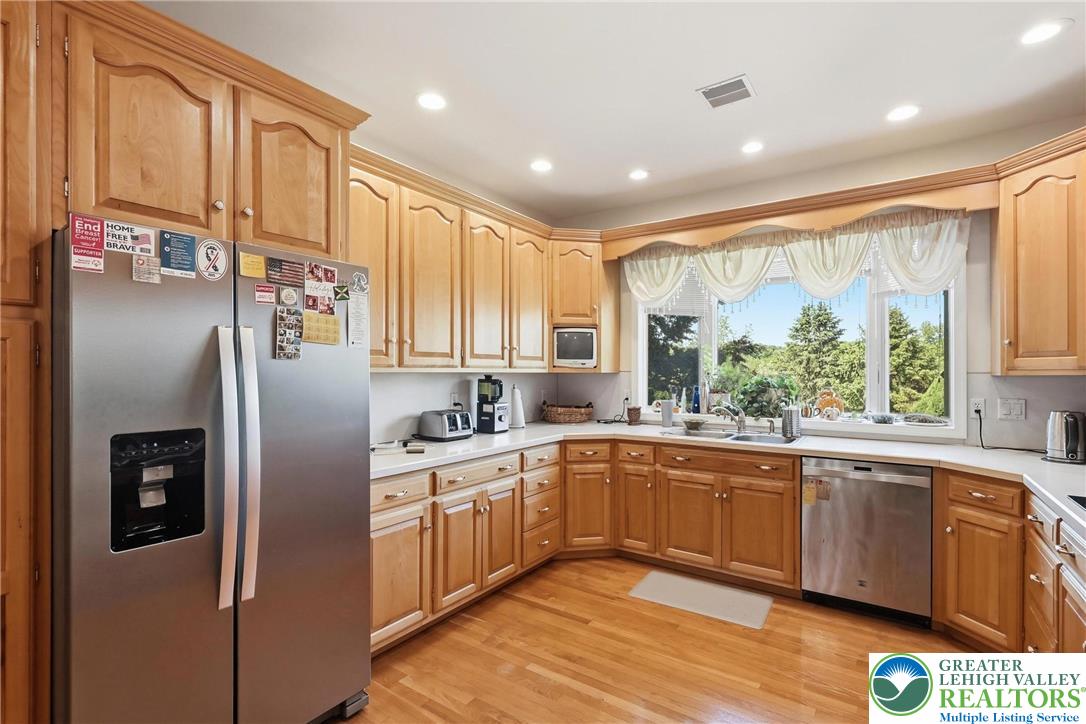 5217 Cider Press Road Schnecksville, PA 18078 - Photo 17 of 54 a kitchen with stainless steel appliances granite countertop a refrigerator sink and cabinets