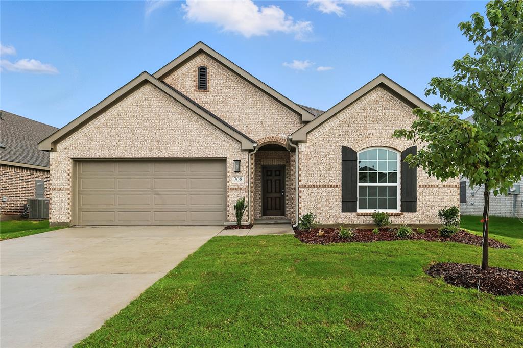 708 Jack Street Lowry Crossing, TX 75407 - Photo 1 of 1 French country inspired facade with brick siding, a garage, a front lawn, and concrete driveway