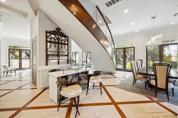 a living room with furniture a fireplace and a large window
