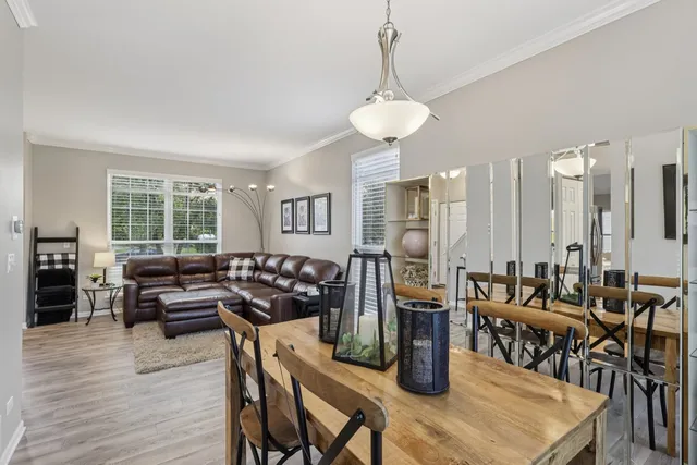 a view of a dining room with furniture and wooden floor