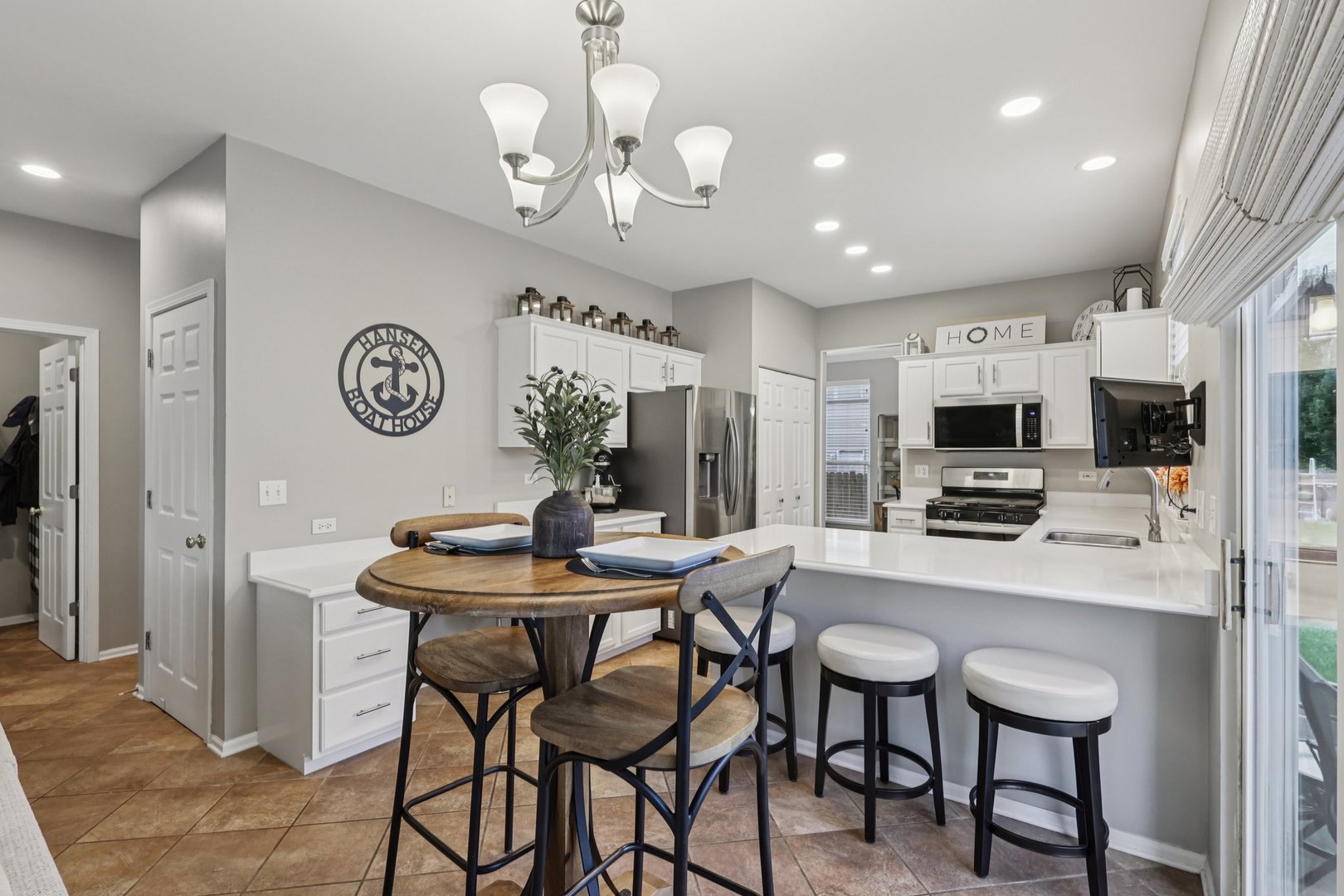 11680 Cape Cod Lane Huntley, IL 60142 - Photo 13 of 47 a view of a dining room with furniture a kitchen and chandelier