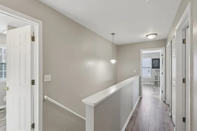 a view of hallway with wooden floor