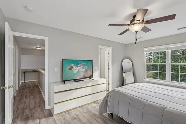 a bedroom with two beds and a large window