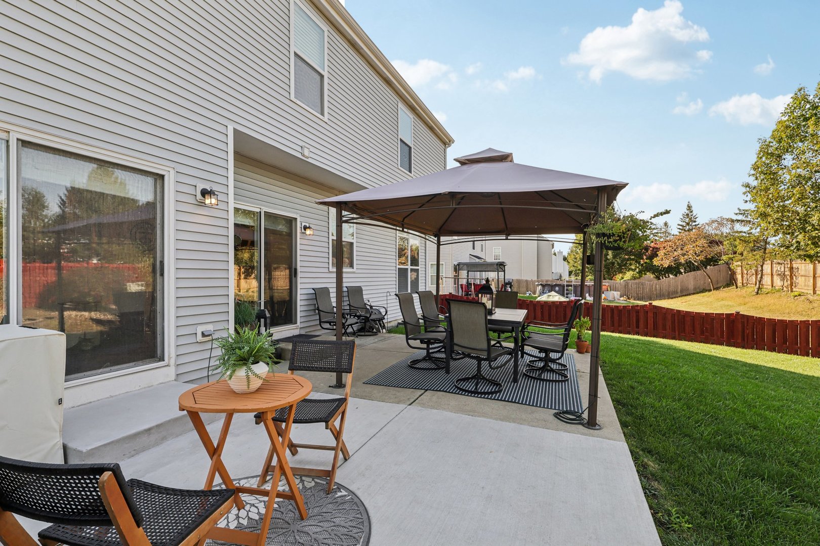 11680 Cape Cod Lane Huntley, IL 60142 - Photo 39 of 47 a view of a patio with table and chairs under an umbrella