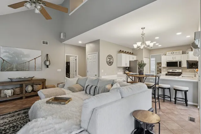 a living room with furniture and a chandelier
