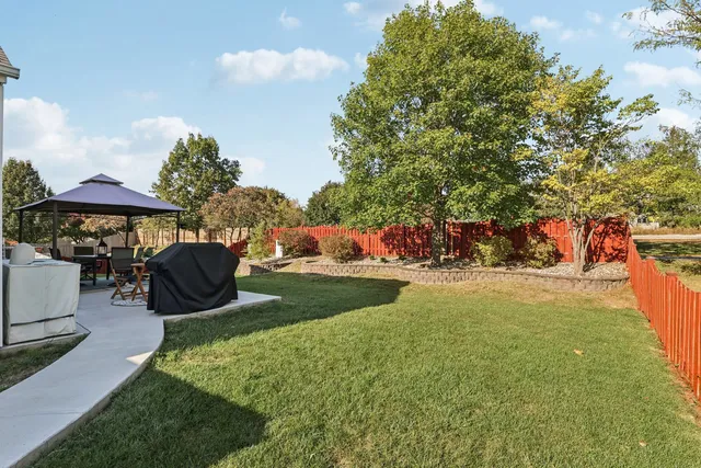 a view of a house with a yard and sitting area