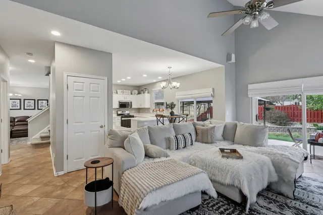 a living room with furniture and a view of kitchen
