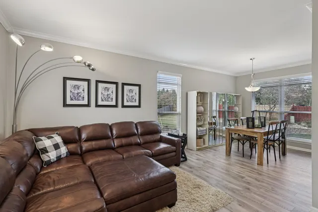 a living room with furniture wooden floor and dining table
