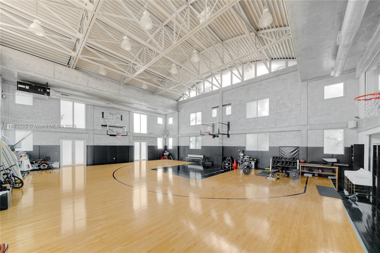 980 West 48th Street Miami Beach, FL 33140 - Photo 8 of 10 a gym with lots of furniture and view of kitchen