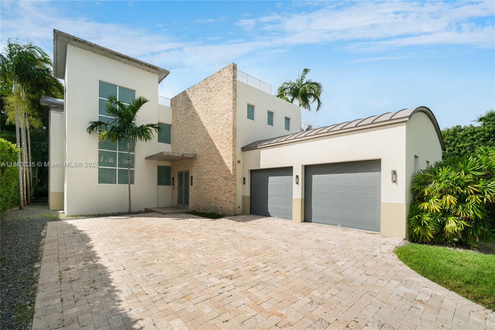 980 West 48th Street Miami Beach, FL 33140 - Photo 9 of 10 a view of a house with a yard and potted plants