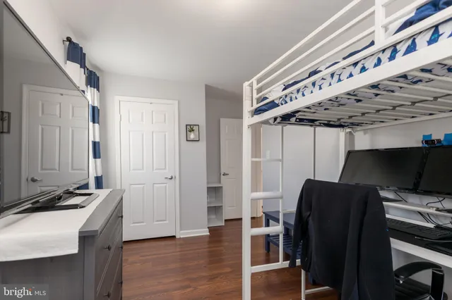 a view of a hallway with workspace and wooden floor