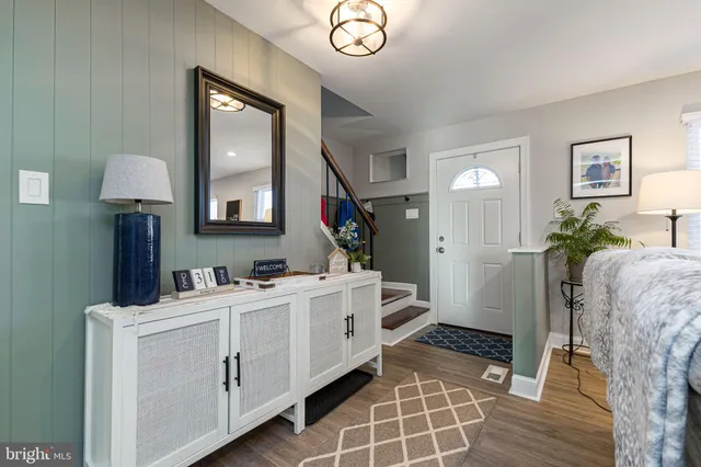 a room that has a mirror and a dresser in it