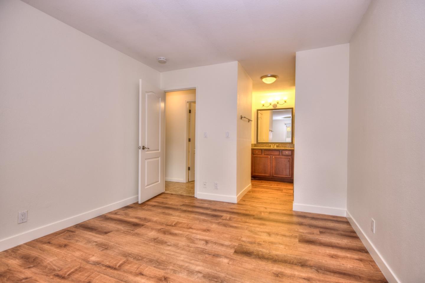 464 Dempsey Road, Unit 264 Milpitas, CA 95035 - Photo 13 of 16 a view of a hallway with wooden floor and a bathroom