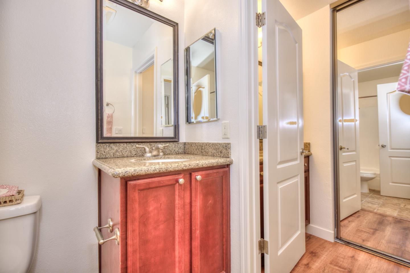 464 Dempsey Road, Unit 264 Milpitas, CA 95035 - Photo 15 of 16 a bathroom with a granite countertop sink and a mirror