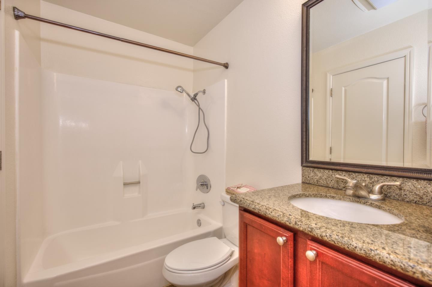 464 Dempsey Road, Unit 264 Milpitas, CA 95035 - Photo 16 of 16 a bathroom with a granite countertop sink toilet and shower