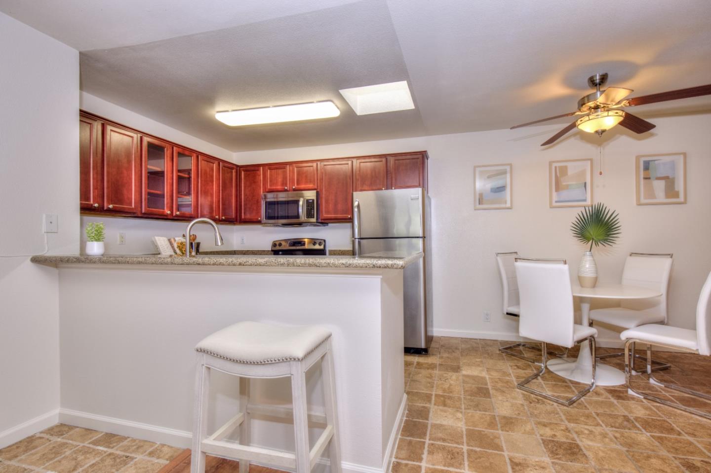 464 Dempsey Road, Unit 264 Milpitas, CA 95035 - Photo 6 of 16 a living room with a couch and a dining table with wooden floor