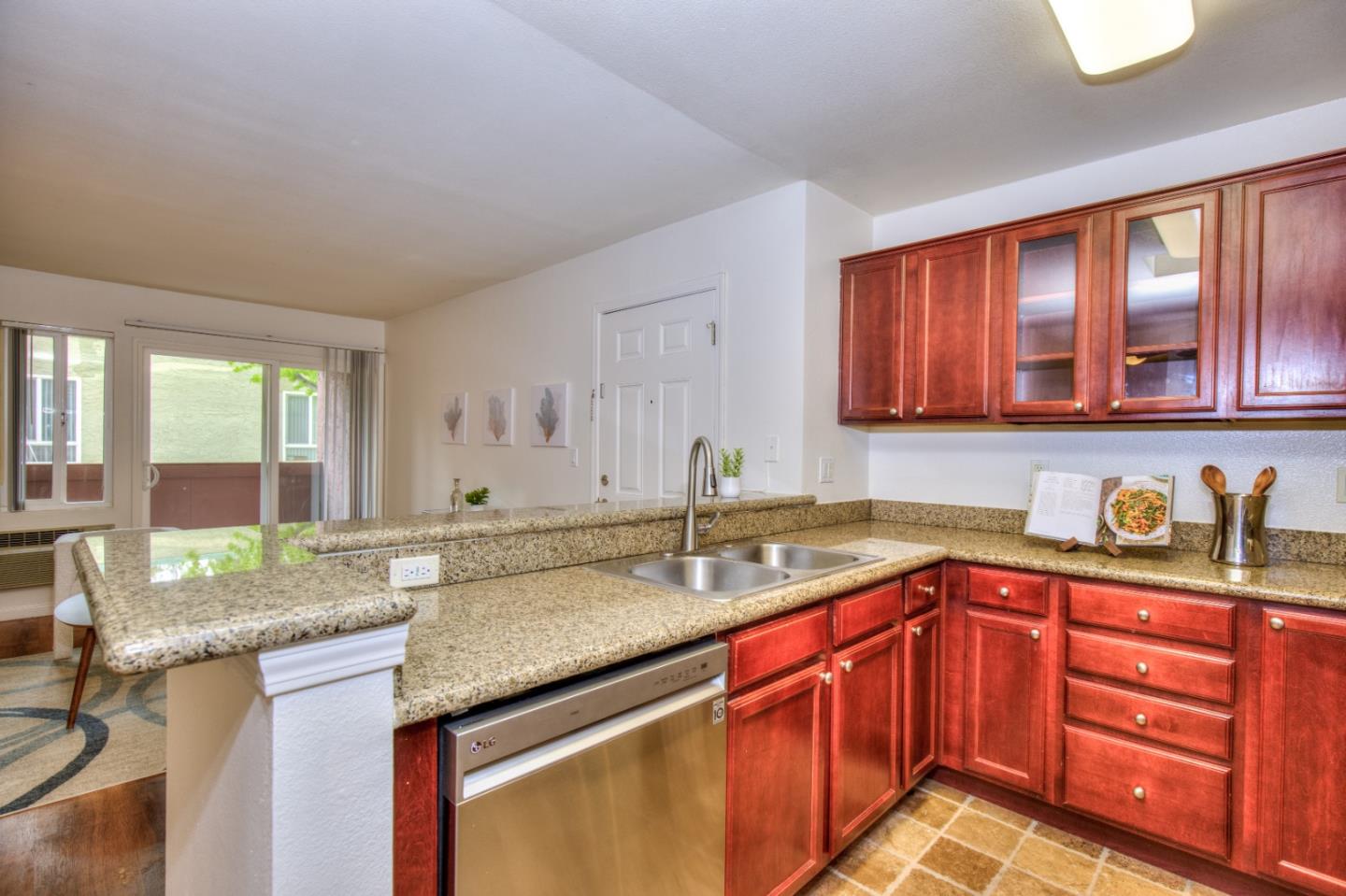 464 Dempsey Road, Unit 264 Milpitas, CA 95035 - Photo 9 of 16 a kitchen with stainless steel appliances granite countertop a sink stove and cabinets