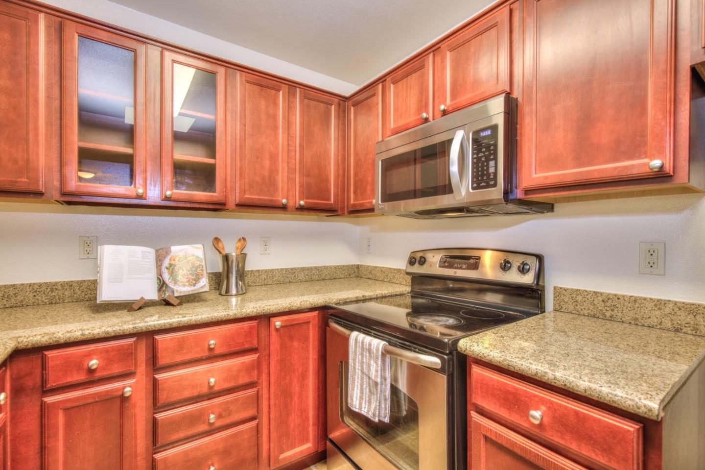 464 Dempsey Road, Unit 264 Milpitas, CA 95035 - Photo 10 of 16 a kitchen with granite countertop a sink stove and cabinets