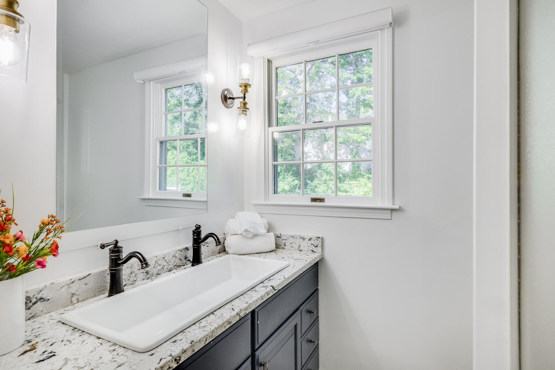 167 Ambergris Circle Brewster, MA 02631 - Photo 41 of 89 a bathroom with a granite countertop sink a mirror and a window