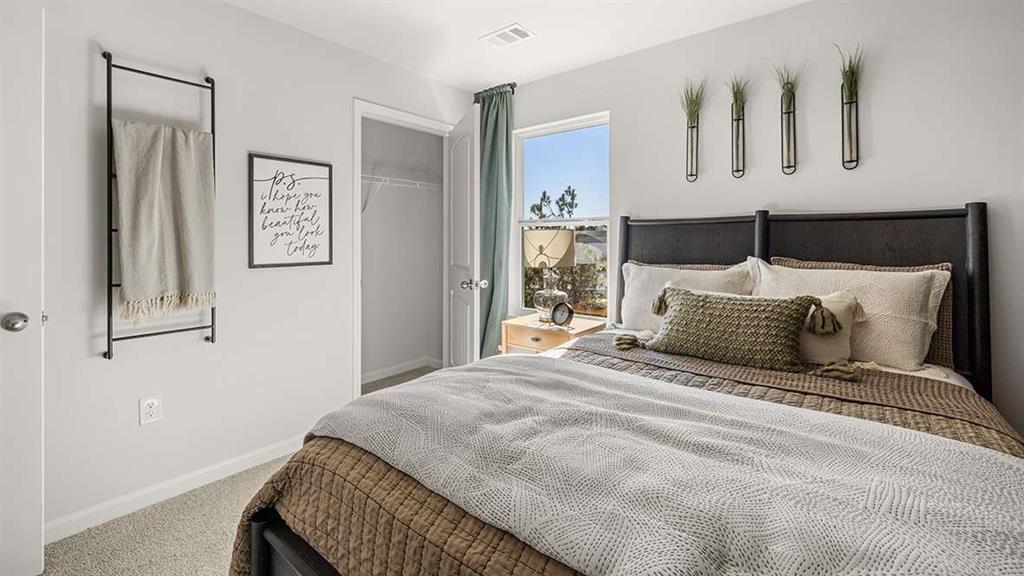 4937 Jatoba Road Acworth, GA 30101 - Photo 16 of 22 a bedroom with a large bed and a window