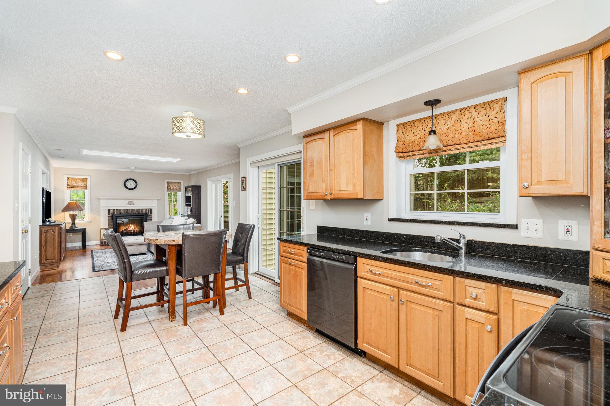 4530 Rincon Place Dumfries, VA 22025 - Photo 12 of 45 a kitchen with stainless steel appliances granite countertop dining table chairs cabinets and a sink