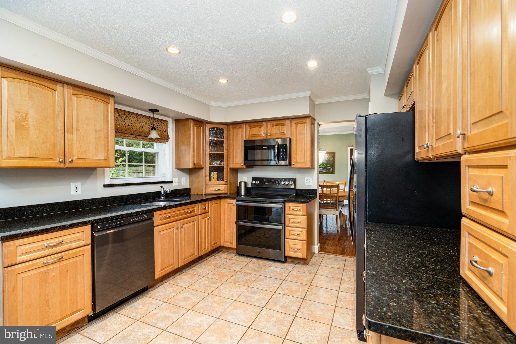 4530 Rincon Place Dumfries, VA 22025 - Photo 13 of 45 a kitchen with stainless steel appliances granite countertop a refrigerator and a stove top oven