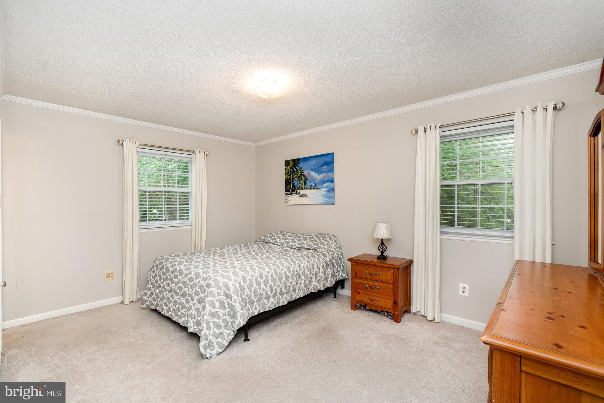 4530 Rincon Place Dumfries, VA 22025 - Photo 21 of 45 a bedroom with a bed and wooden floor