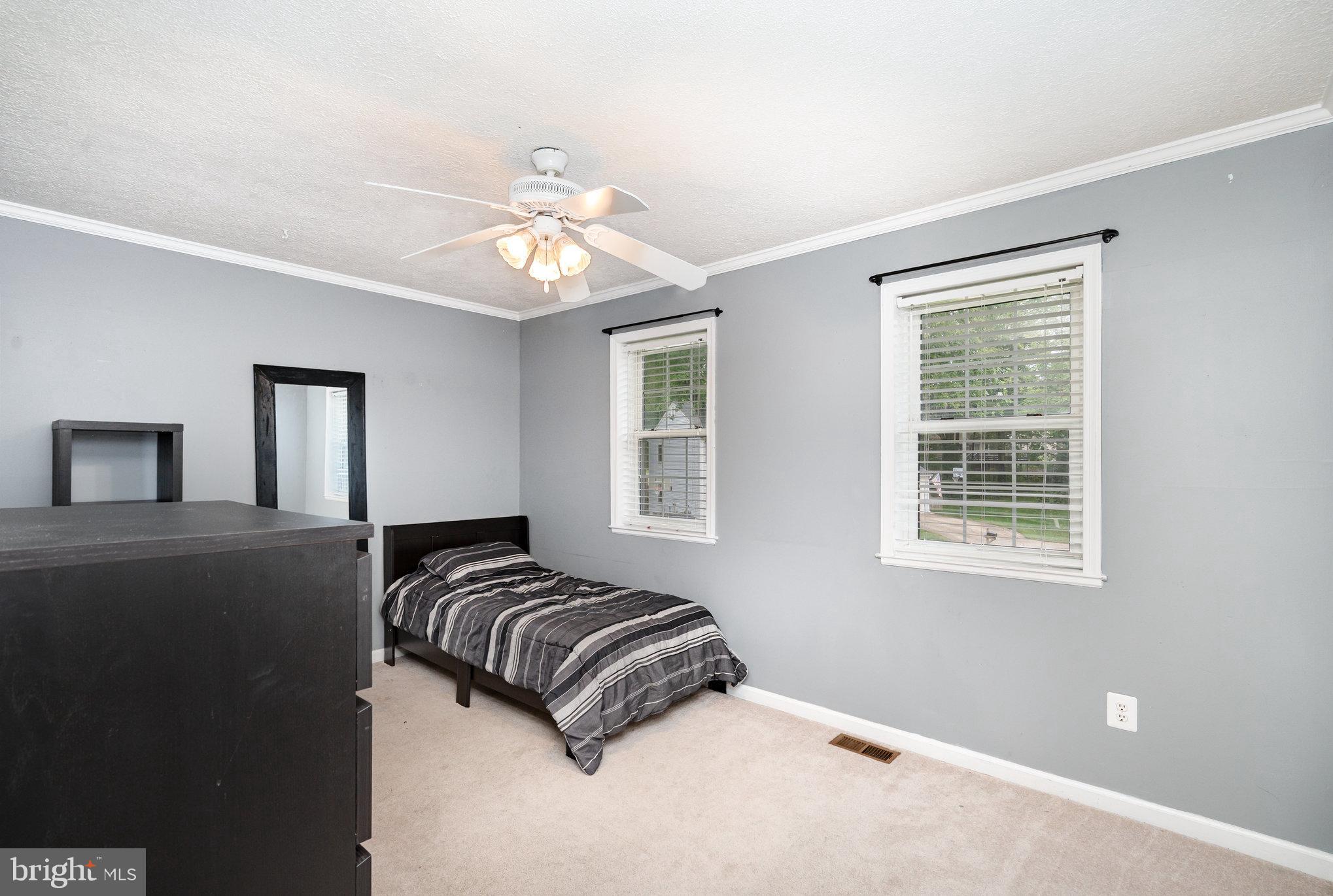 4530 Rincon Place Dumfries, VA 22025 - Photo 26 of 45 a bedroom with a bed and a chandelier
